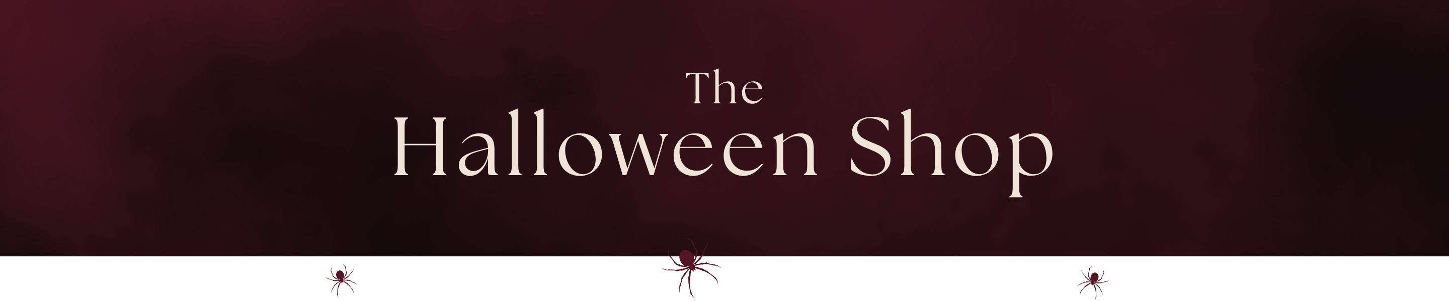 A banner-style graphic with the text 'The Halloween Shop' in white serif lettering over a dark burgundy background, with a white strip at the bottom containing small spider silhouettes.