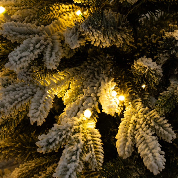 4' Pre-Lit Artificial Flocked Christmas Tree with 100 Warm White LED Lights in Decorative Trunk Planter