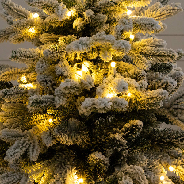 4' Pre-Lit Artificial Flocked Christmas Tree with 100 Warm White LED Lights in Decorative Trunk Planter