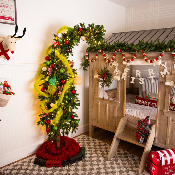 Children's room decorated for Christmas with a tree, garlands, and festive decor.